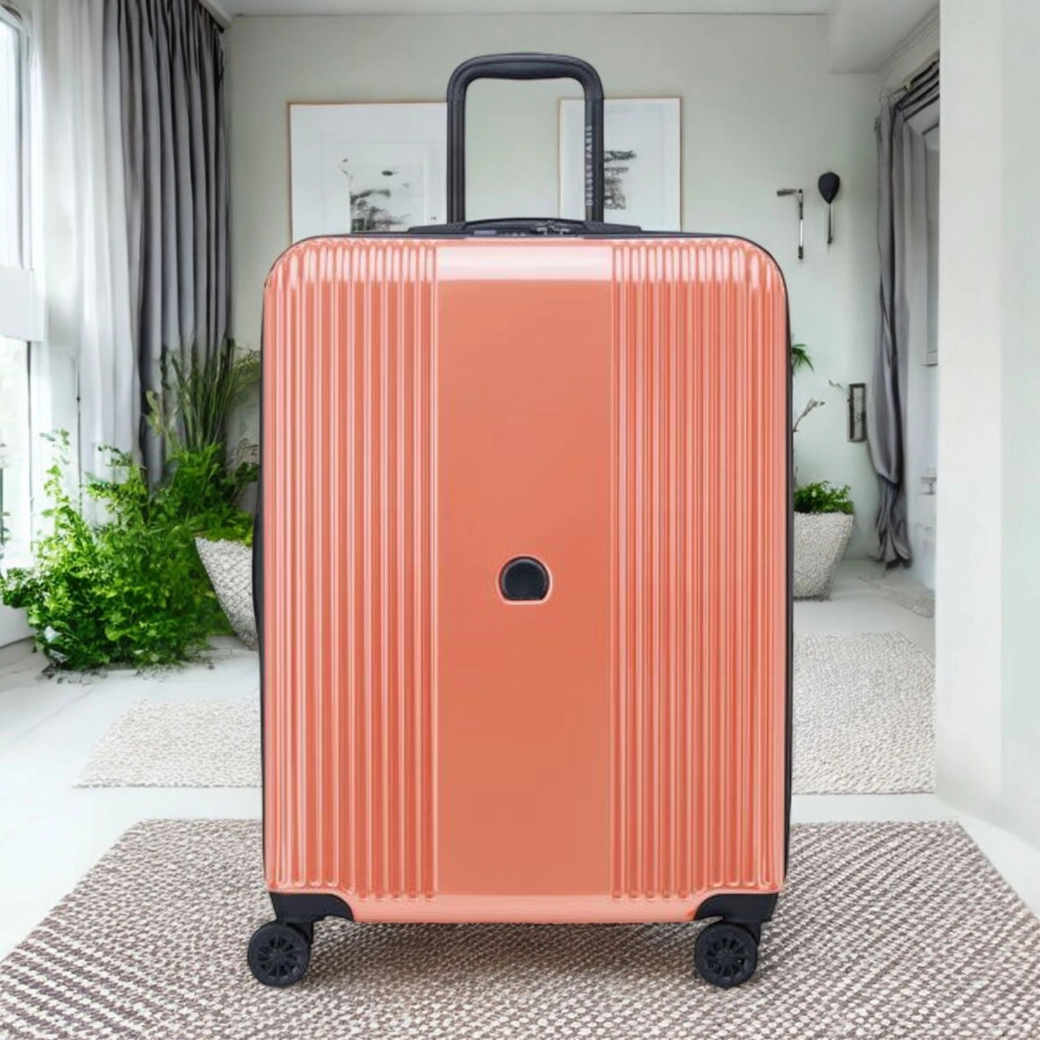 Delsey Ophelia luggage bag in coral color with sturdy wheels and retractable handle for easy travel
