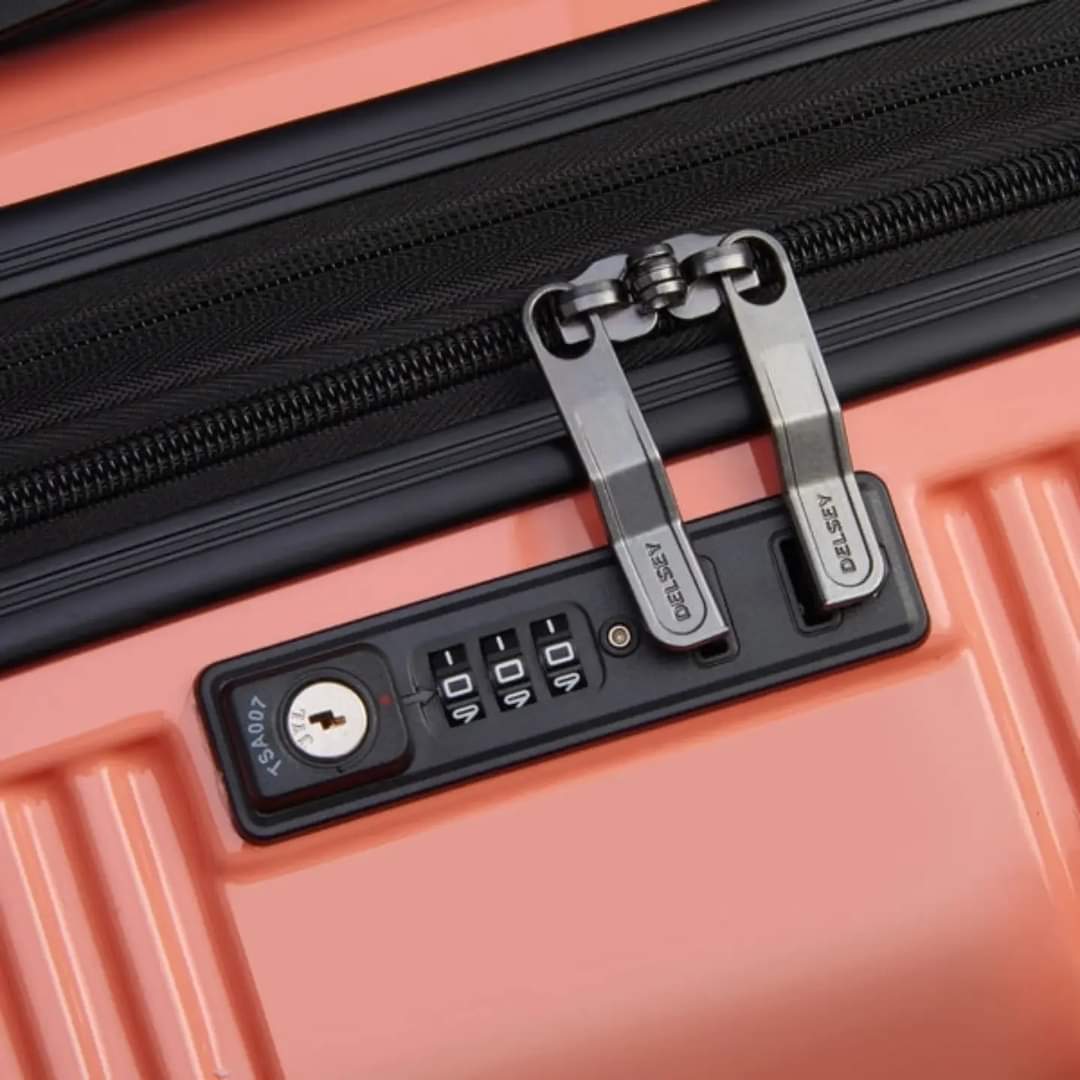 Close-up of the secure lock system on Delsey Ophelia luggage bag in coral color