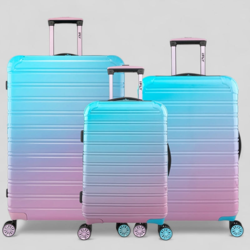 Set of three IFLY FIBERTECH suitcases in gradient blue and pink, perfect for travel in Pakistan