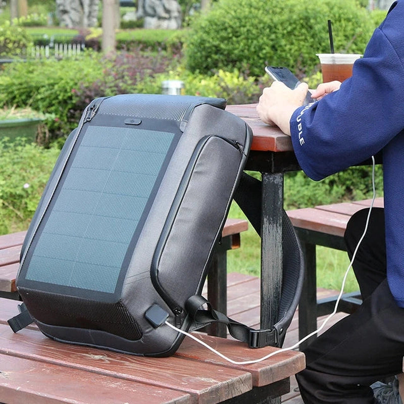 Haris Luggage solar charging backpack Pakistan with a solar panel and charging cable on a table